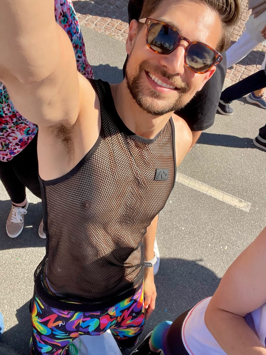 Jeremiah selfie. Wearing a black mesh tanktop and rainbow graffiti tights
